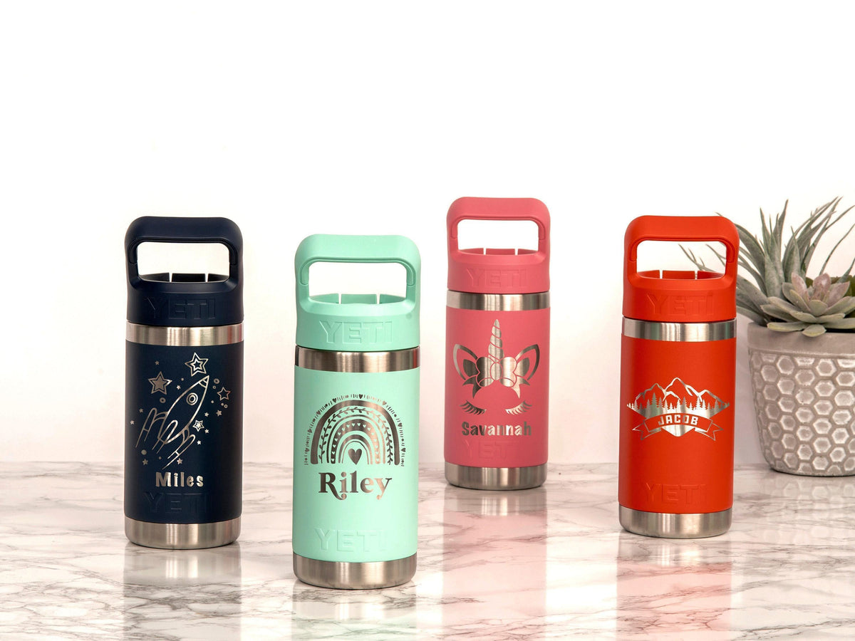 Original Marcy finished engraving examples on YETI kids bottles: rocket, rainbow, unicorn and mountain designs